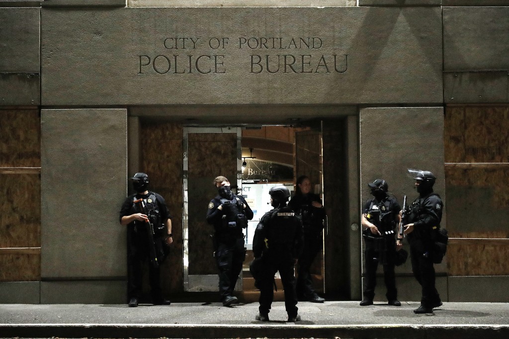 Officer stood in front of the Portland Police Bureau's North Precinct on the night of September 26, 2020, as people demonstrated against police violence and racial inequality.