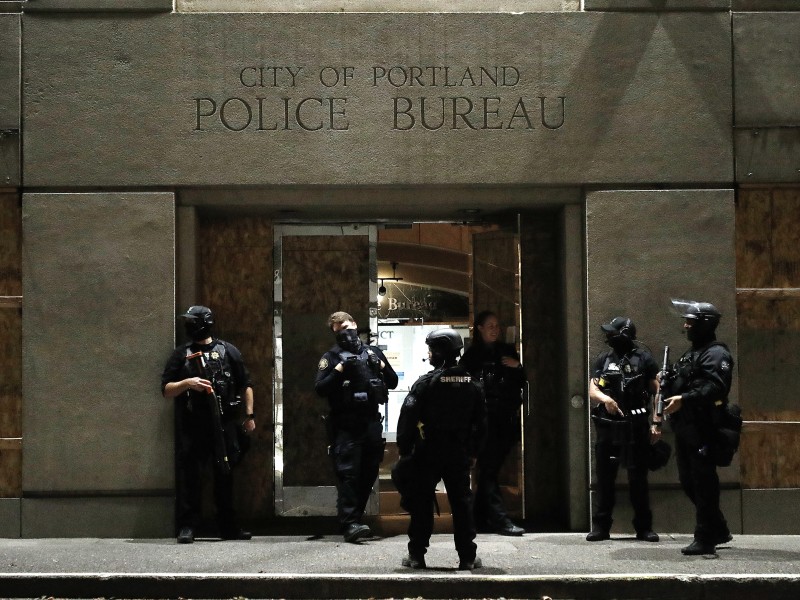 Officer stood in front of the Portland Police Bureau's North Precinct on the night of September 26, 2020, as people demonstrated against police violence and racial inequality.