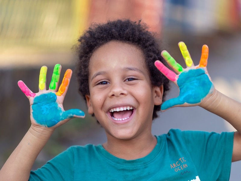 Happy pre-school boy with painted hands
