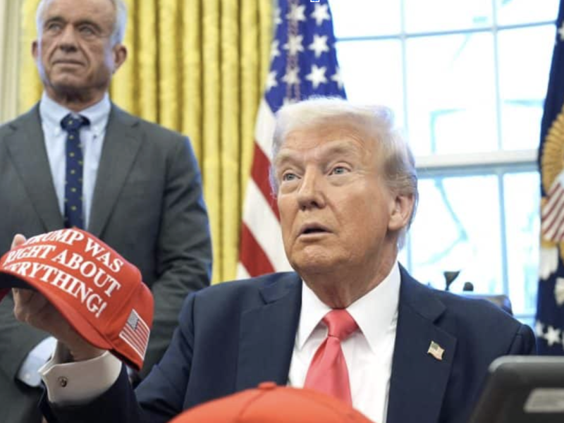 RFK Jr. stands beside President Donald Trump.