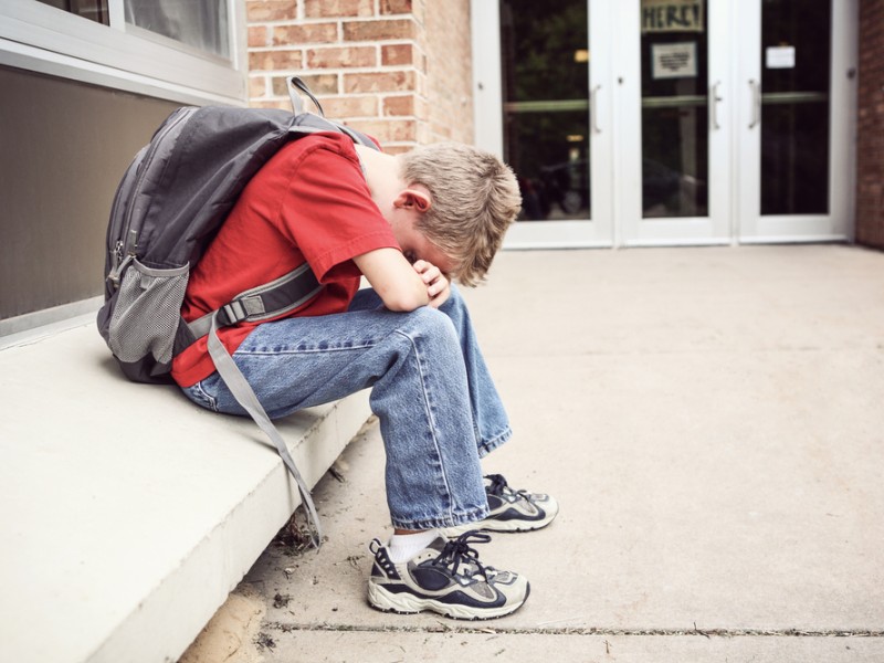 depressed boy in hallway