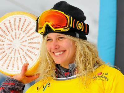 Lindsay Jacobellis, an American athlete, poses at the podium after winning the 2012 world championship at the FIS World Cup Snowboard Cross finals.