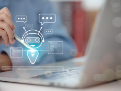 A child sits at a laptop computer, holding a stylus pen. An illustration on top of the image shows a robot with speech bubbles around its head.