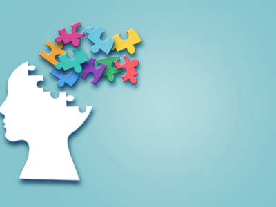 A digital illustration of an incomplete human head with puzzle pieces scattered around it.