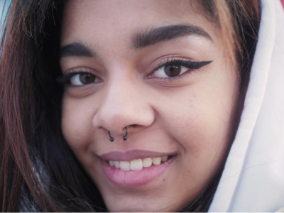 A close-up of a teenage girl in a hoodie