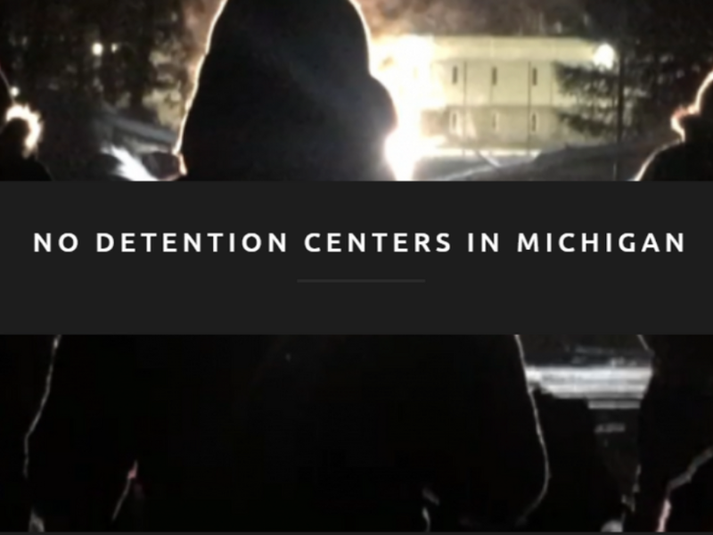 A group of people stand outside at night, their backs turned to the camera. Text over the photo reads "No detention centers in Michigan."