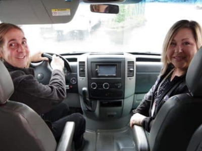 Two people sit in the front of a mobile crisis unit in Shasta County, California.
